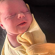 Amelia joined the competition — help win amazing prizes! baby, newborn, sleeping, yellow_blanket, soft, peaceful, infant, closeup, face, skin, wrapped, cozy, child, portrait, adorable, cute, resting, human, young, blanket