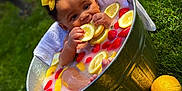 Royalty is registered to the contest to win money with this photo: baby, bow, child, cute, fruit, grass, lemon_slices, metal_tub, milk_bath, nature, outdoor, playful, portrait, red_bow, relaxing, strawberries, summer, toddler, water, yellow_bow