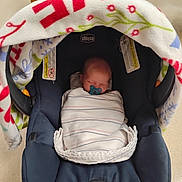 Jerry is registered to the contest to win money with this photo: newborn, baby, car_seat, blanket, pacifier, sleeping, infant, chicco, fabric, striped, fleece, indoor, child, comfort, seatbelt, soft, peaceful, wrapped, head, rest