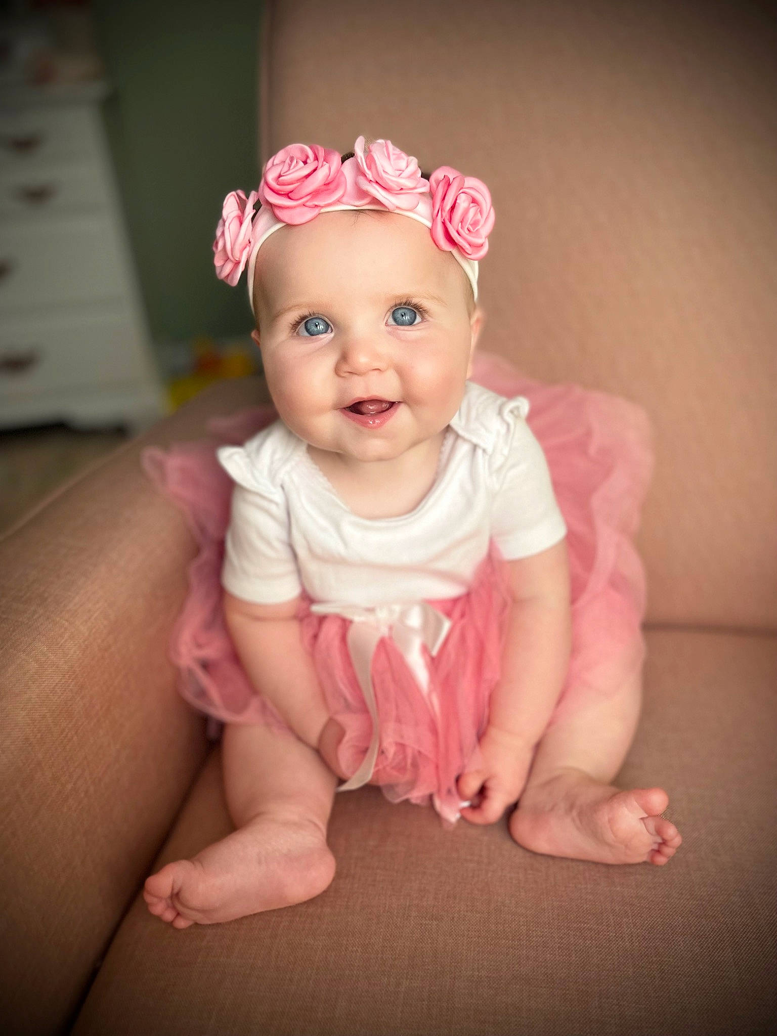 Meadow is registered to the contest to win money with this photo: baby, baby_toddler_clothing, cheek, dress, eye, finger, flash_photography, hair_accessory, happy, headband, headgear, headpiece, iris, joy, lip, peach, person, petal, pink, sleeve