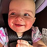baby, baby_girl, car_seat, child, child_safety, closeup, clothing, cute, dinosaur_print, face, hand, happy, infant, portrait, safety, seat, seatbelt, skin, smile, young