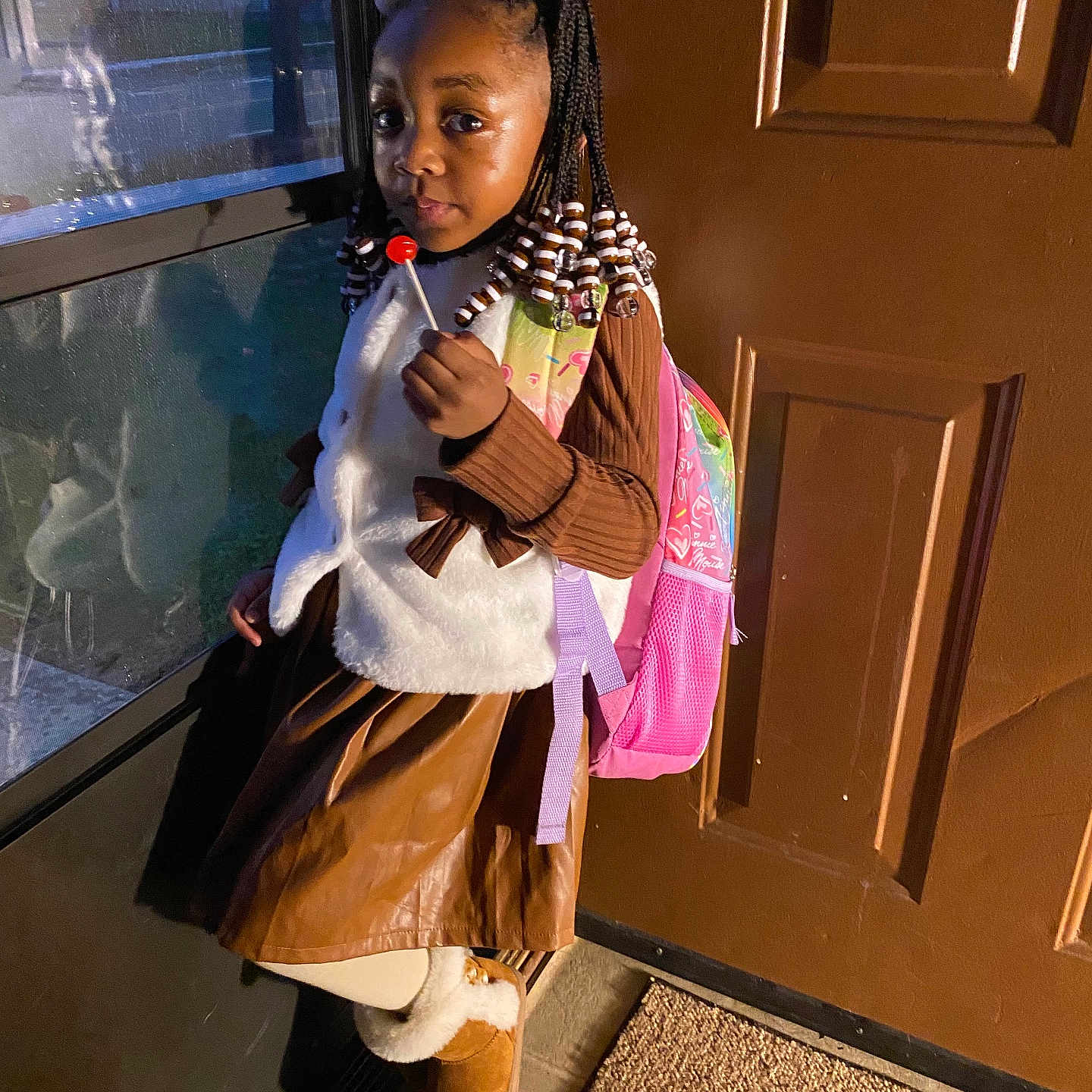 Nariya is registered to the contest to win money with this photo: blackhair, braid, child, clothing, coat, cornrows, door, face, female, footwear, girl, hair, head, person, shoe, sitting, sleeve, standing, student, window