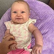 Willow joined the competition — help win amazing prizes! baby, infant, smile, hand, pacifier, cushion, purple, pink, clothing, holding, cute, happy, person, indoor, child, face, skin, small, seated, comfort