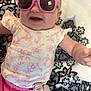 baby, sunglasses, pink, floral, clothing, blanket, pattern, smile, happy, infant, cute, person, portrait, child, laying, accessory, fashion, headwear, fun, indoors