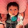 Edyn is registered to the contest to win money with this photo: baby, infant, pacifier, car_seat, seatbelt, buckle, pink_pillow, wide_eyes, surprised, closeup, newborn, hand, face, hair, skin, clothing, indoors, portrait, cushion, safety_strap