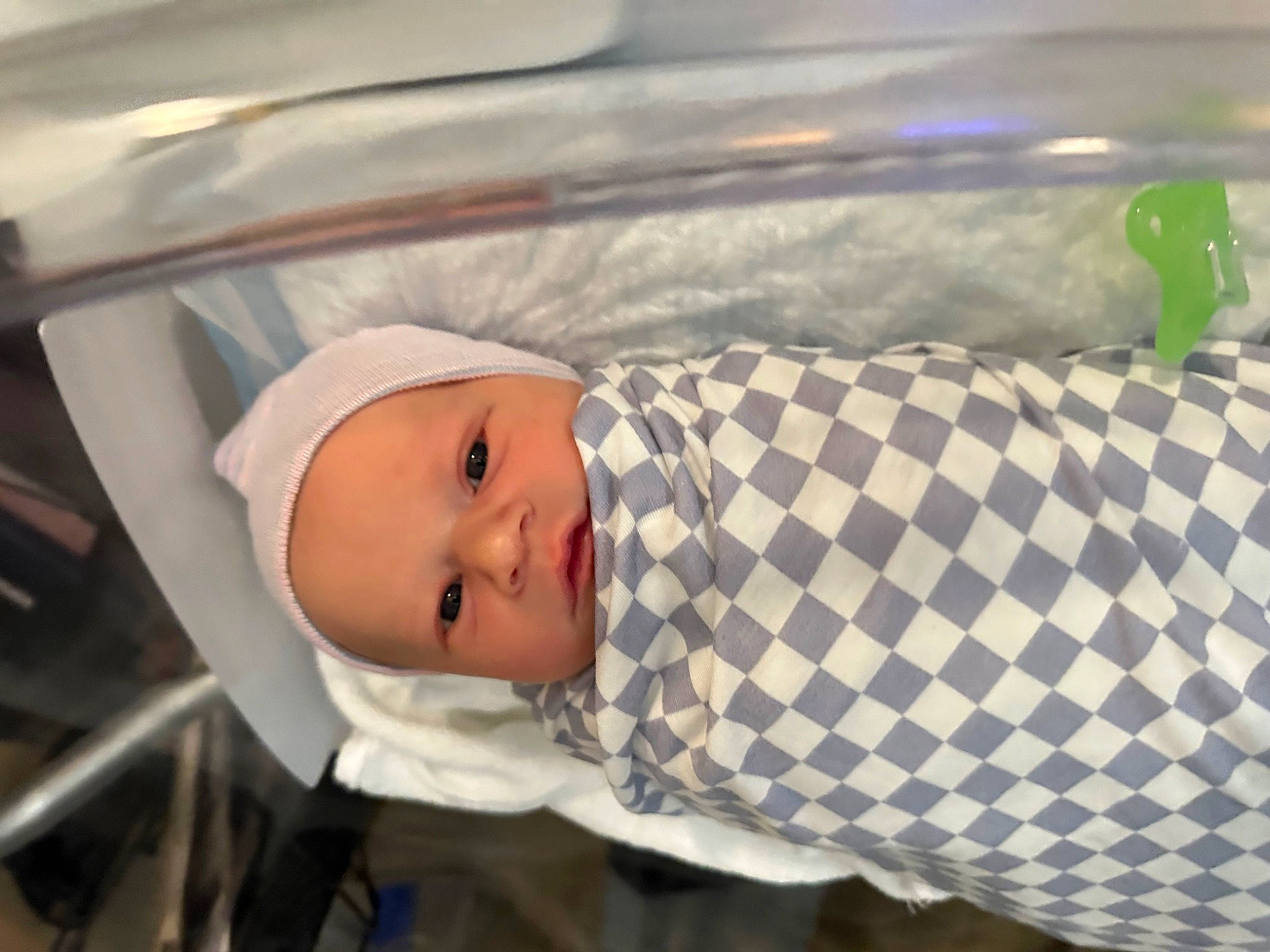 Chase is registered to the contest to win money with this photo: baby, baby_products, baby_safety, baby_toddler_clothing, cap, child, comfort, fashion_accessory, hat, headwear, linens, pattern, person, sleeve, toddler, vehicle_door, windshield