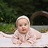 baby, infant, knitted_clothing, pink, blanket, outdoor, nature, grass, portrait, cute, child, face, headwear, crawling, happy, young, soft_light, closeup, warm_clothing, smiling
