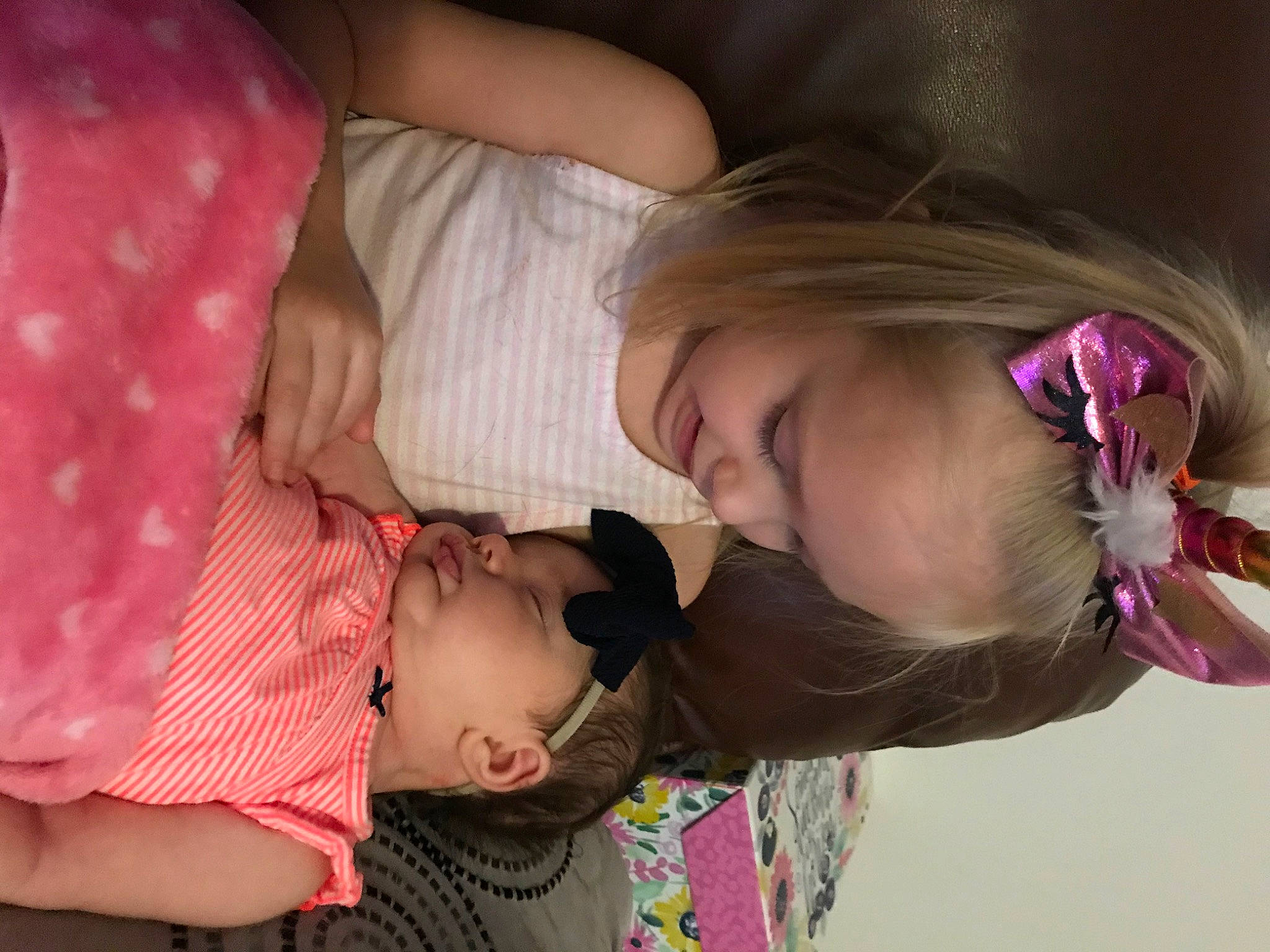 Raylee is registered to the contest to win money with this photo: baby, cheek, child, ear, fun, gesture, interaction, leg, love, mouth, neck, nose, person, pink, skin, smile, toddler