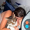 animal, arm, bed, blanket, cat, closeup, comfort, cozy, cuddle, feline, hug, human, indoor, person, pillow, relaxation, resting, sleepy, tabby_cat, wall