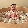 baby, child, smiling, headband, pink_outfit, ball_pit, balls, beige, cream, white, indoor, happy, cute, infant, portrait, sitting, play, toy, childhood, joy