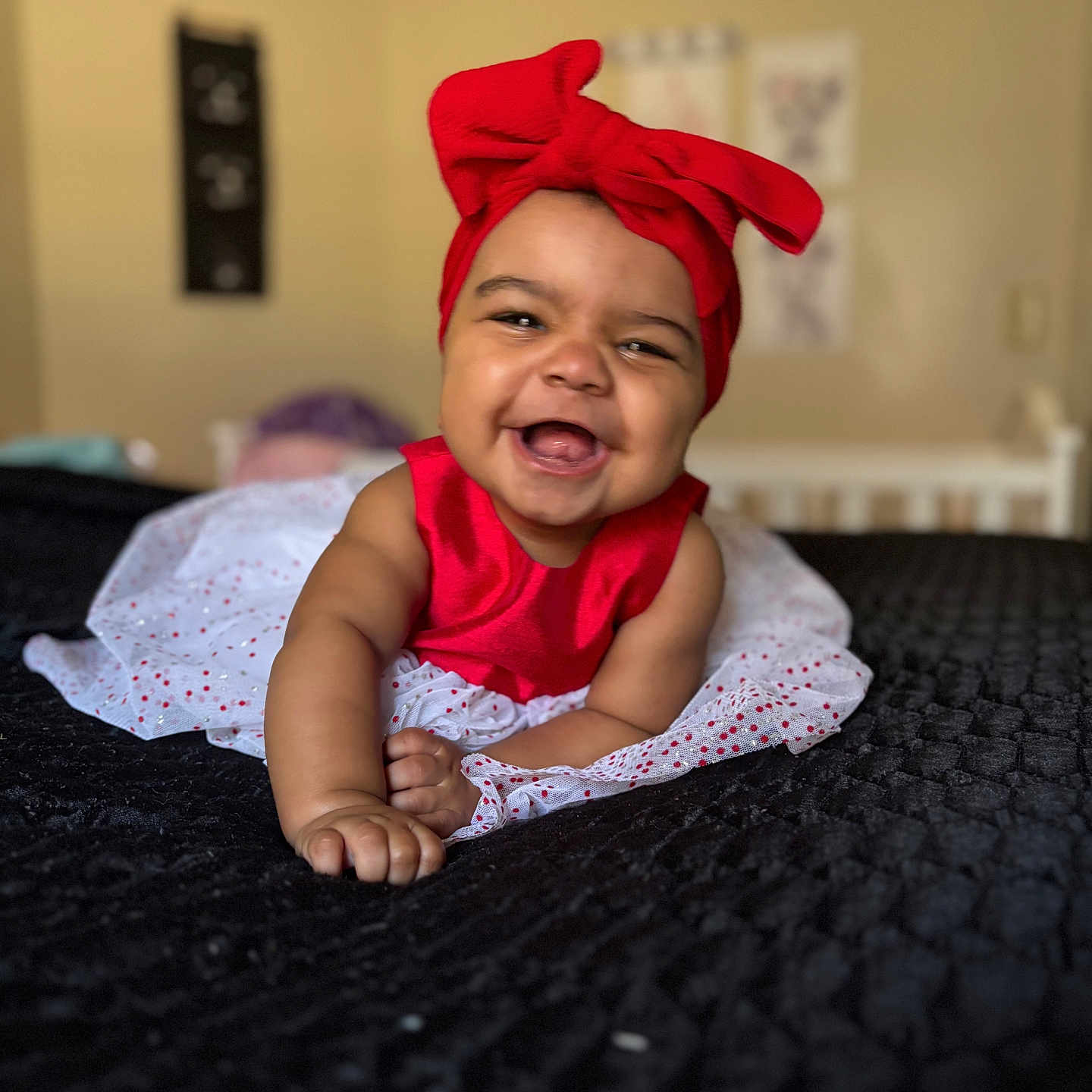 Amira is registered to the contest to win money with this photo: baby, babylaughing, bodypart, bonnet, cap, clothing, dress, face, finger, hand, happy, hat, head, laughing, newborn, person, photography, portrait, sitting, smile