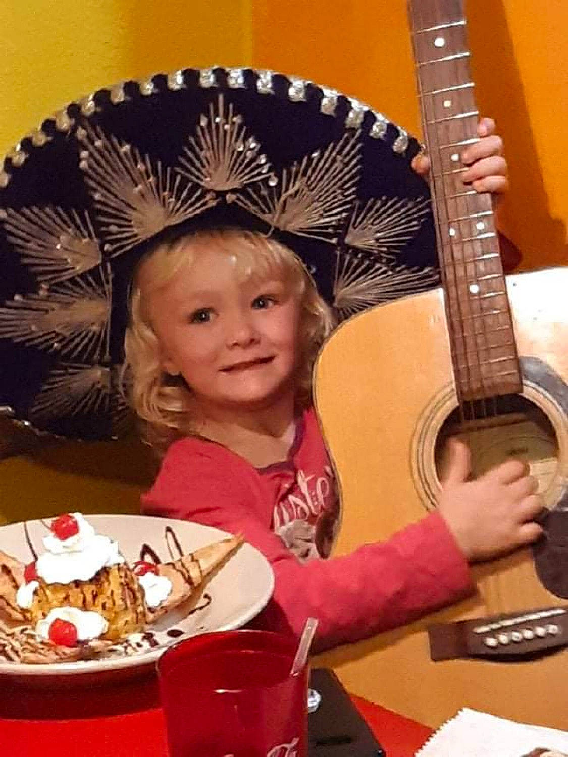 Embyr is registered to the contest to win money with this photo: cake, child, folk_instrument, food, guitar, guitar_accessory, joy, music, musical_instrument, musical_instrument_accessory, musician, person, plate, plucked_string_instruments, smile, string_instrument, string_instrument_accessory, table, tableware, toddler