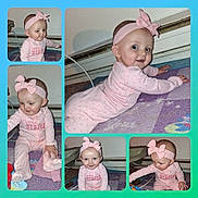 Topanga joined the competition — help win amazing prizes! baby, child, pink_onesie, headband, bow, indoor, carpet, crawling, sitting, playful, curious, smiling, cute, portrait, infant, floor, toy, blanket, person, young_child