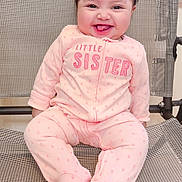 America joined the competition — help win amazing prizes! baby, child, smiling, pink_onesie, sitting, happy, face, infant, cute, indoor, clothing, footed_pajamas, mesh_chair, young_child, portrait, person, baby_girl, expression, joyful, hair