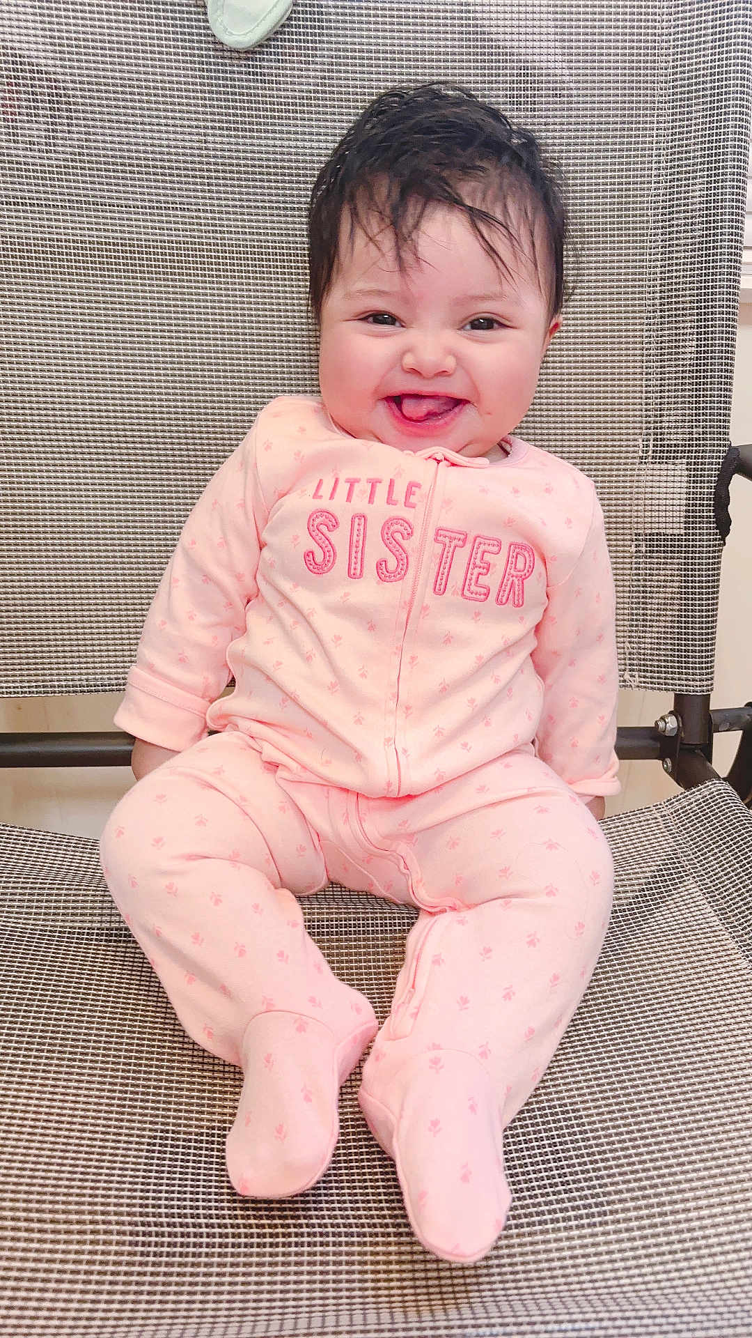 America joined the competition — help win amazing prizes! baby, child, smiling, pink_onesie, sitting, happy, face, infant, cute, indoor, clothing, footed_pajamas, mesh_chair, young_child, portrait, person, baby_girl, expression, joyful, hair