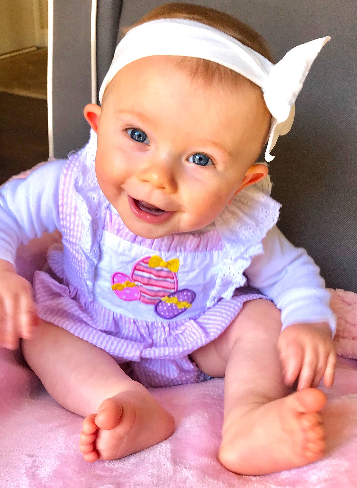 Stella Grace joined the competition — help win amazing prizes! baby, baby_laughing, baby_products, baby_toddler_clothing, cheek, child, finger, hair_accessory, hand, headband, headgear, lip, person, pink, product, sitting, skin, smile, toddler, tummy_time
