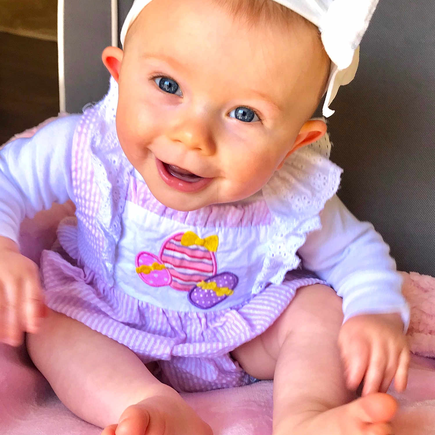 Stella Grace joined the competition — help win amazing prizes! baby, baby_laughing, baby_products, baby_toddler_clothing, cheek, child, finger, hair_accessory, hand, headband, headgear, lip, person, pink, product, sitting, skin, smile, toddler, tummy_time
