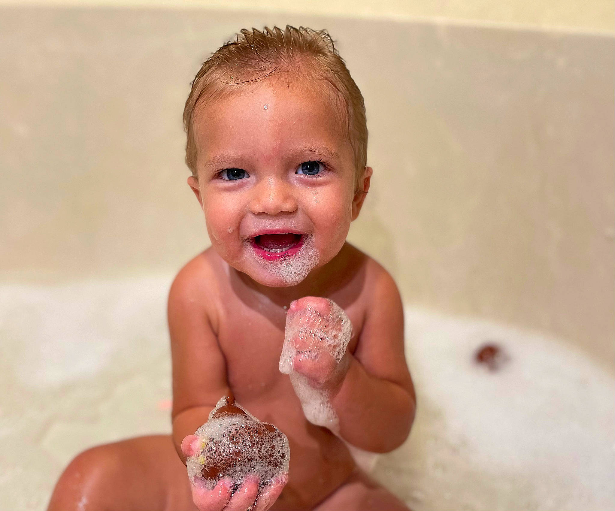 Colton is registered to the contest to win money with this photo: baby, bathing, bathtub, carmine, chest, child, face, finger, foot, fun, gesture, hand, happy, joy, liquid, nail, person, smile, thumb, toddler