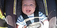 Phoenix joined the competition — help win amazing prizes! baby, blue_eyes, car_seat, child, cute, fabric, grass, happy, infant, joy, outdoor, playful, portrait, safety_harness, seat, seatbelt, smiling, striped_clothing, sunlight, young_child