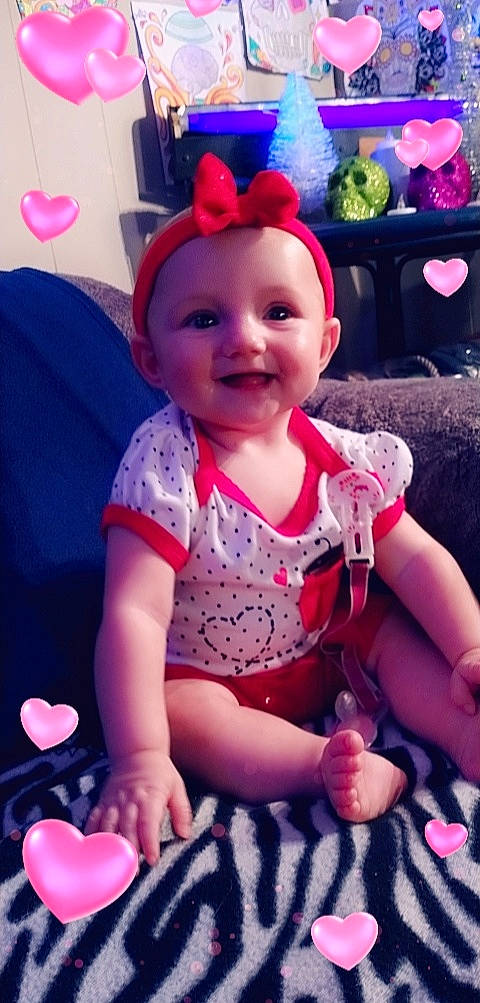 Novaleigh is registered to the contest to win money with this photo: baby, baby_toddler_clothing, blue, cheek, child, finger, fun, happy, joy, magenta, pattern, person, pink, purple, red, sitting, skin, sleeve, smile, t_shirt