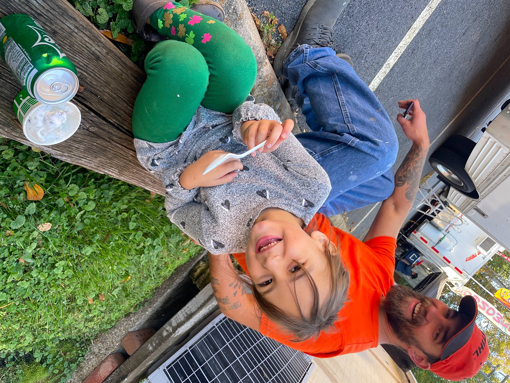 Audrey is registered to the contest to win money with this photo: child, event, fun, grass, green, hat, headwear, joy, leisure, party_supply, person, plant, recreation, sitting, smile, stuffed_toy, sunglasses, t_shirt, toy, tree