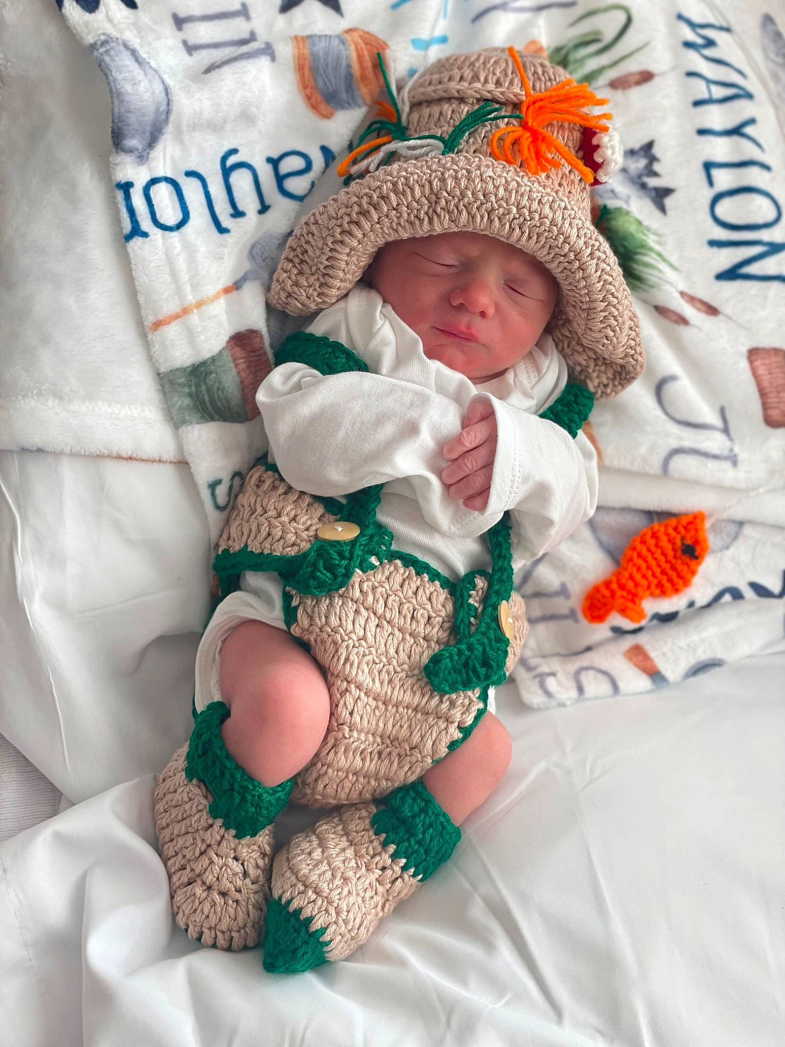 Justin is registered to the contest to win money with this photo: baby, baby_products, baby_sleeping, baby_toddler_clothing, beanie, bedding, cap, comfort, fictional_character, headgear, headwear, knit_cap, knitting, linens, pattern, peach, person, room, sleeve, toddler