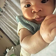 Zyhir is registered to the contest to win money with this photo: arm, baby, bed, blanket, blue_cloth, bottle, close_up, curtains, cute, expression, face, indoors, infant, person, portrait, resting, skin, sleepwear, soft_light, young_child