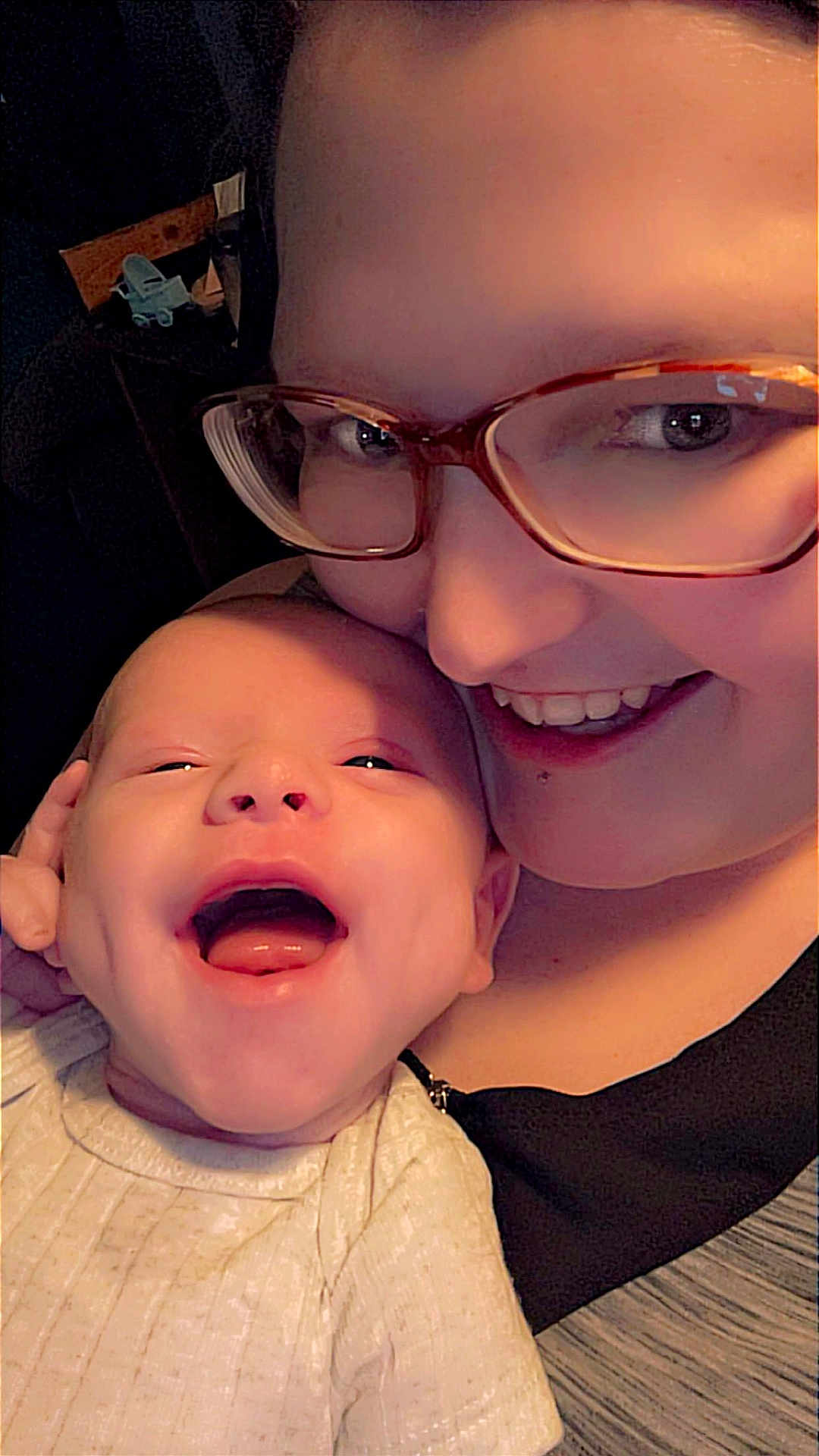 Leo is registered to the contest to win money with this photo: baby, infant, smile, laughing, adult, glasses, face, closeup, happy, joy, person, skin, head, love, family, candid, warmth, affection, together, cozy