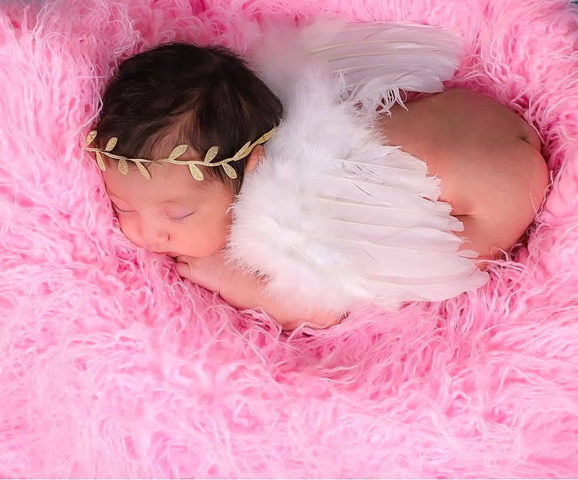 Caroline is registered to the contest to win money with this photo: baby, baby_toddler_clothing, cheek, child, chin, eyebrow, hair_accessory, happy, headgear, iris, lip, magenta, mammal, nose, person, petal, pink, skin, sleeve, textile