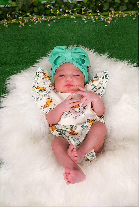 Caroline is registered to the contest to win money with this photo: baby, baby_products, baby_toddler_clothing, costume, costume_hat, dress, fashion_accessory, fun, grass, hair_accessory, happy, headgear, headpiece, headwear, human_body, jewellery, pattern, person, pink, sitting