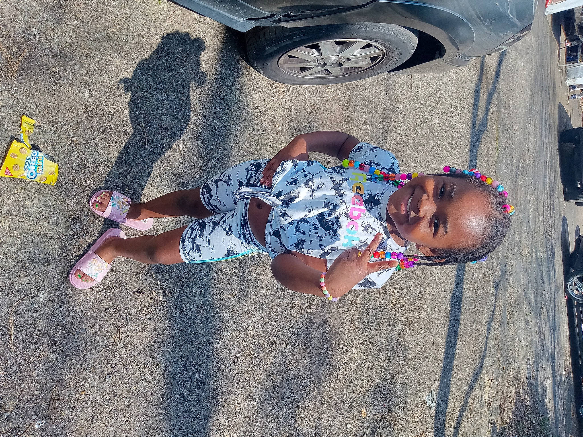 Beautiful is registered to the contest to win money with this photo: asphalt, automotive_tire, child, city, concrete, cool, electric_blue, fun, hat, human_leg, joy, leisure, person, road, road_surface, shadow, sidewalk, tire, toddler, tree