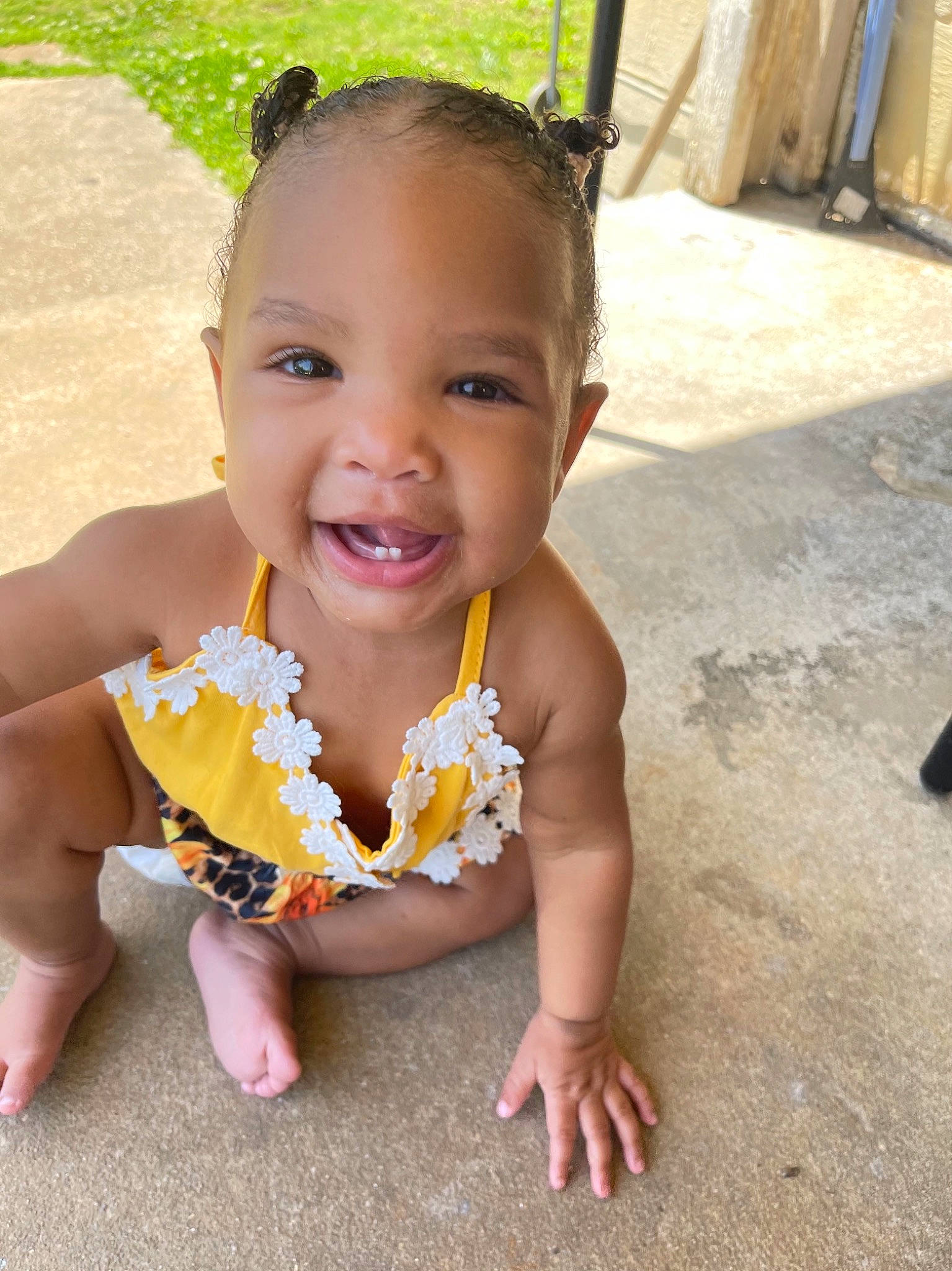Nylah is registered to the contest to win money with this photo: baby, baby_toddler_clothing, cheek, chest, chin, dress, finger, grass, hand, happy, head, human_body, joy, leisure, lip, mouth, person, pink, skin, smile