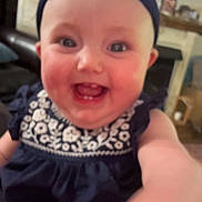 Hailey joined the competition — help win amazing prizes! baby, baby_girl, background, black, child, closeup, clothing, cute, face, furniture, hand, happy, headband, indoor, living_room, person, pink, portrait, skin, smiling