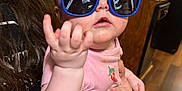 Hailey joined the competition — help win amazing prizes! adult, baby, blue_glasses, cabinet, child, curious, cute, expression, eyewear, face, hand, holding, indoor, kitchen, long_hair, person, pink_shirt, sunglasses, table, wood_floor
