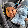 baby, infant, car_seat, bandana, stuffed_animal, toy, blue, black, clothing, child, cute, face, headwear, seatbelt, closeup, expression, indoor, person, portrait, young_child