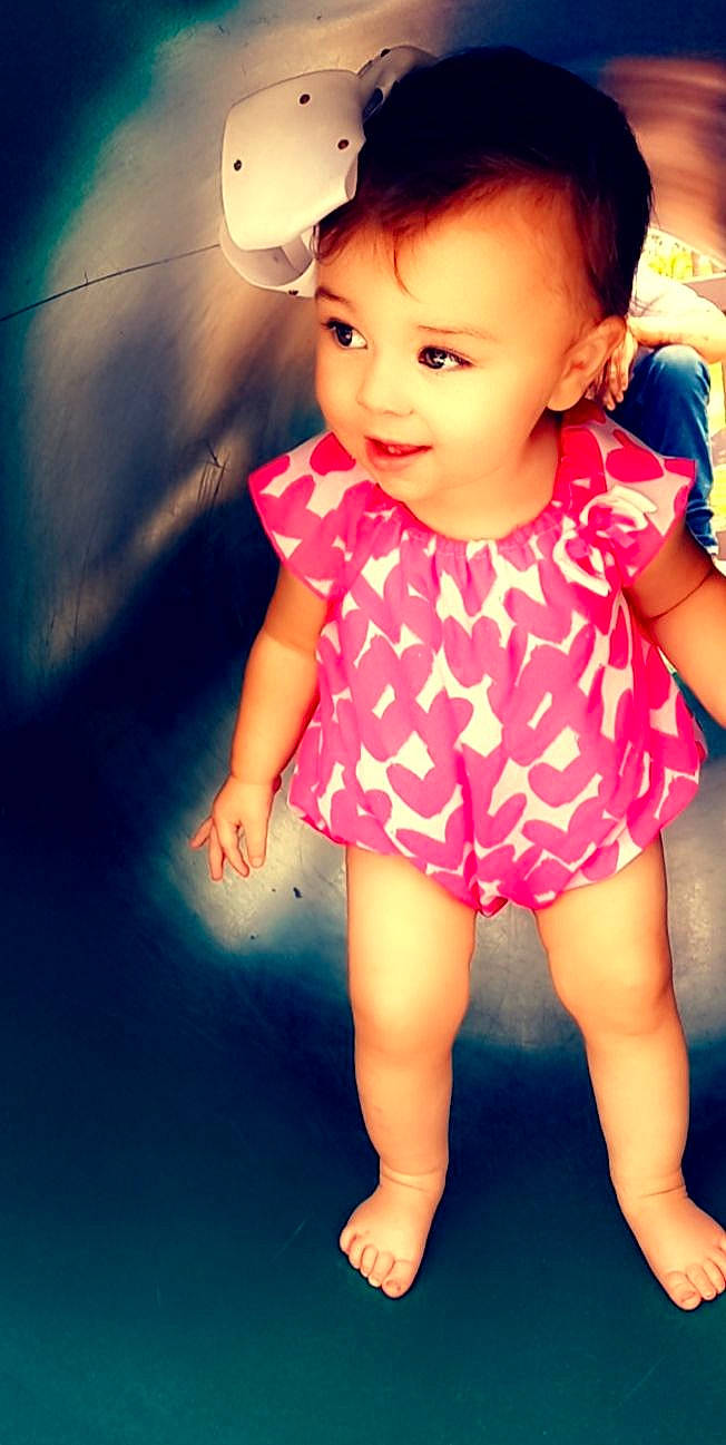 Malayah is registered to the contest to win money with this photo: baby_toddler_clothing, blue, cheek, dress, eye, finger, flash_photography, gesture, happy, human, human_body, iris, lip, mouth, neck, nose, person, pink, skin, sleeve