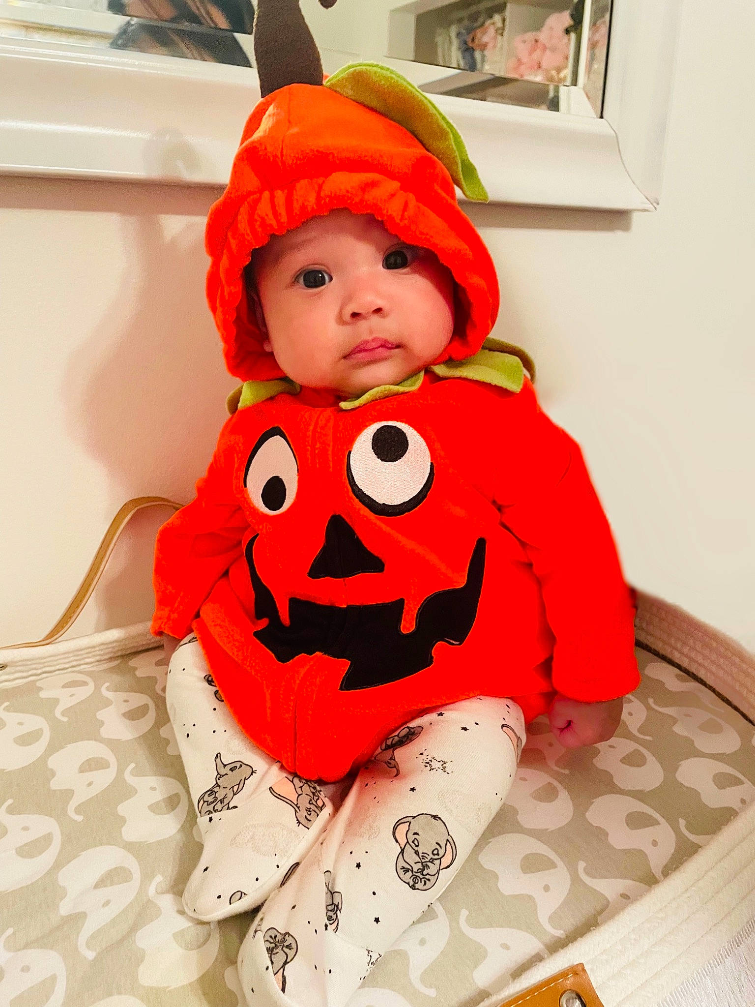 Isabella Rae joined the competition — help win amazing prizes! baby, baby_toddler_clothing, beanie, cap, carmine, child, costume, costume_accessory, costume_hat, fictional_character, flooring, fur, headwear, orange, pattern, person, personal_protective_equipment, picture_frame, room, sitting