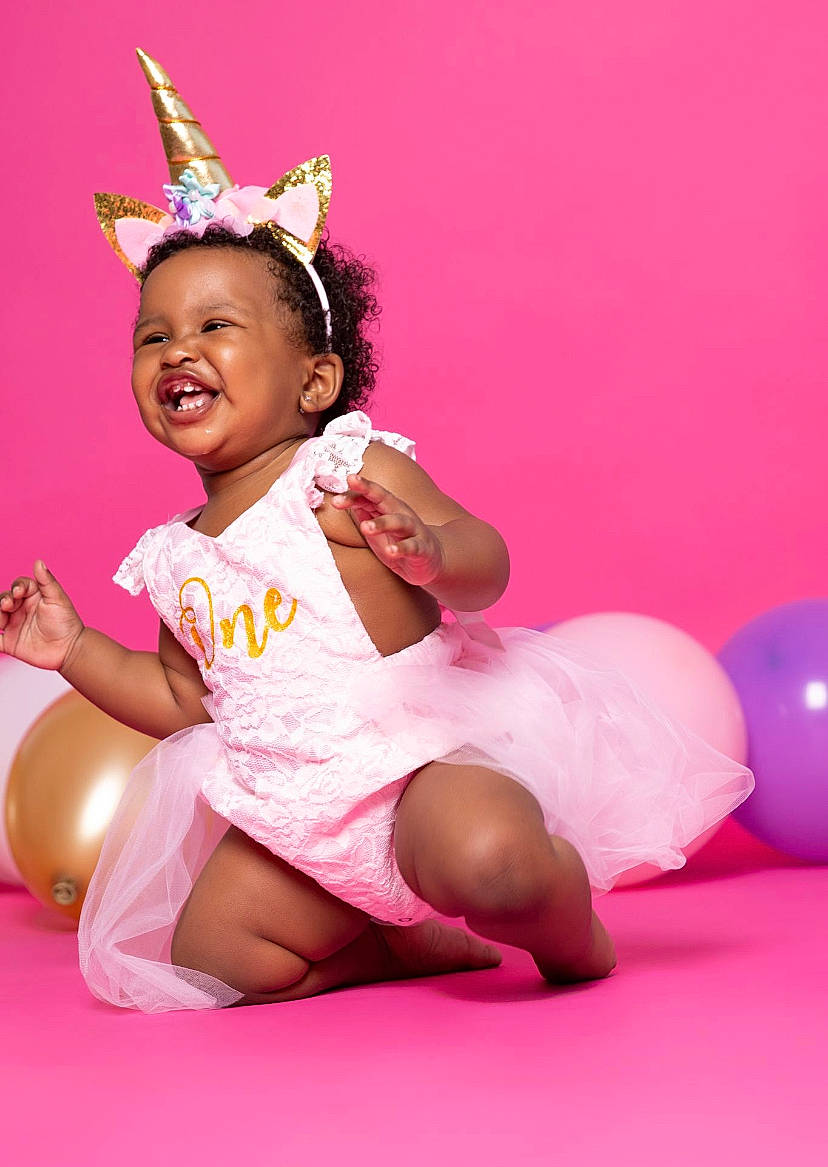 Nova joined the competition — help win amazing prizes! baby, baby_toddler_clothing, child, costume_hat, event, foot, happy, hat, headband, headpiece, human_body, human_leg, leg, leisure, magenta, person, petal, pink, skin, thigh