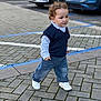 toddler, child, walking, street, pavement, jeans, shirt, vest, sneakers, cars, parking_lot, outdoor, curb, sidewalk, person, fashion, casual, young_child, daytime, urban