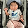 Anya is registered to the contest to win money with this photo: baby, child, hat, stroller, cushion, pink_pants, white_tshirt, face, person, infant, clothing, seat, cute, portrait, indoor, comfortable, looking, hands, feet, newborn