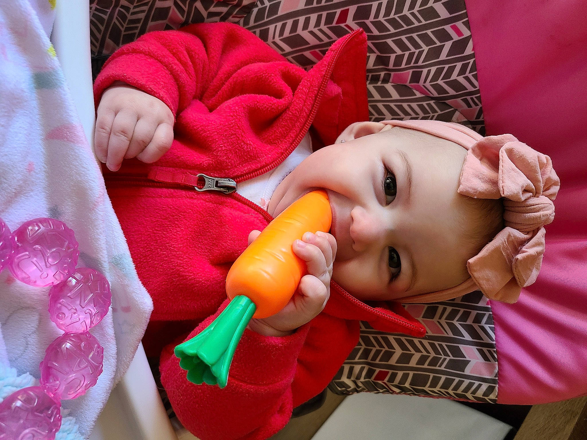 Maisie is registered to the contest to win money with this photo: baby, baby_toddler_clothing, cheek, eye, eyelash, face, finger, happy, head, headwear, iris, lip, mouth, nail, nose, person, pink, red, skin, textile