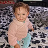 Neveah is registered to the contest to win money with this photo: baby_bed, bed, blanket, blue_pants, child, cozy, crib, curly_hair, face, furniture, happy, home, indoor, person, pink_jacket, polka_dots, room, smiling, television, toddler