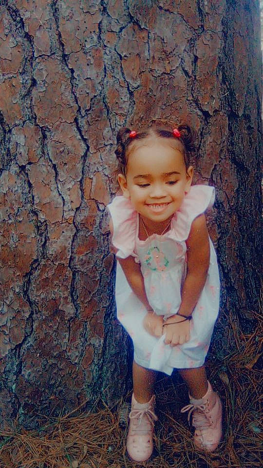 Cashmere is registered to the contest to win money with this photo: baby_toddler_clothing, child, chin, flash_photography, fun, grass, happy, joy, leisure, pattern, people_in_nature, person, plant, shorts, sitting, skin, smile, soil, t_shirt, toddler