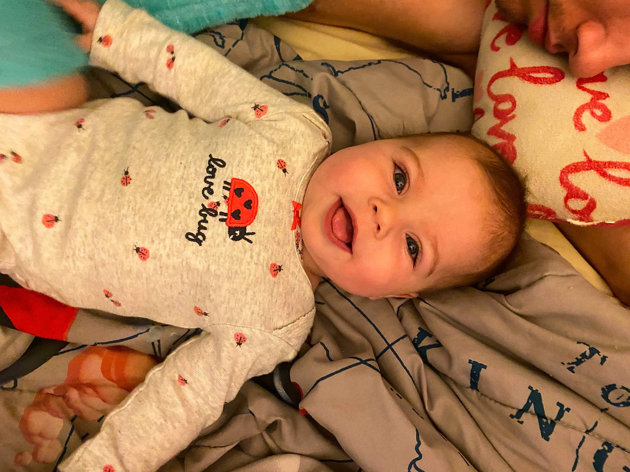 Mattie is registered to the contest to win money with this photo: baby_toddler_clothing, cheek, chin, comfort, eye, face, finger, happy, head, human_body, mammal, mouth, nose, person, product, skin, sleeve, smile, textile, toddler