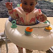 Allyanna joined the competition — help win amazing prizes! baby, child, walker, indoor, floor, onesie, butterfly_pattern, smiling, happy, toy, curly_hair, headband, person, crawling, carpet, curtain, flooring, playtime, infant, home