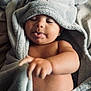 Malia is registered to the contest to win money with this photo: baby, towel, elephant_towel, tongue_out, smiling, cozy, cute, infant, child, skin, blanket, soft, hooded_towel, playful, indoors, portrait, baby_hand, wrapped, relaxed, sleepy