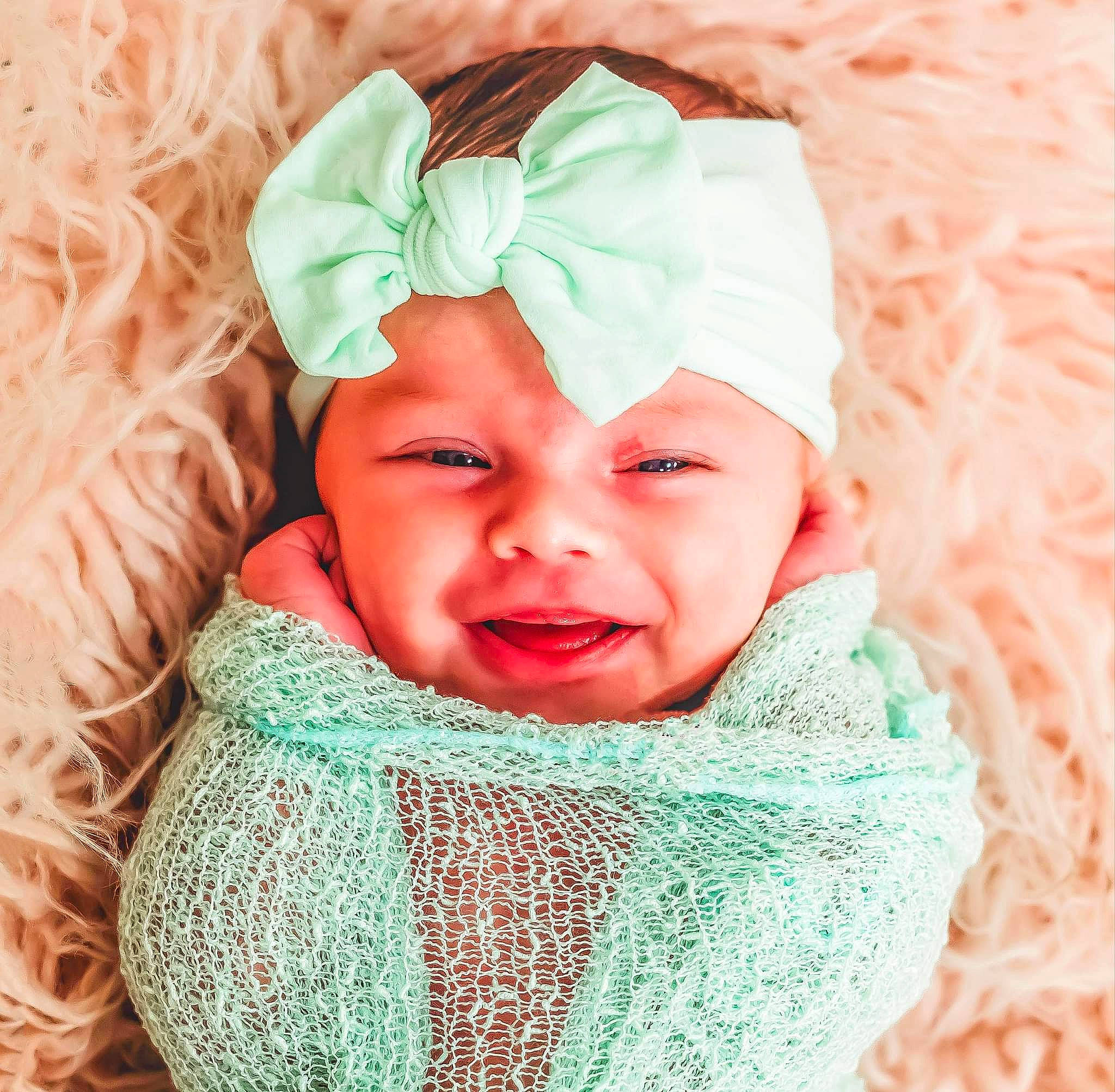 Francesca is registered to the contest to win money with this photo: aqua, baby, baby_toddler_clothing, child, clothing, costume_hat, face, green, happy, headgear, headwear, linens, outerwear, person, pink, shawl, sleeve, smile, textile, toddler