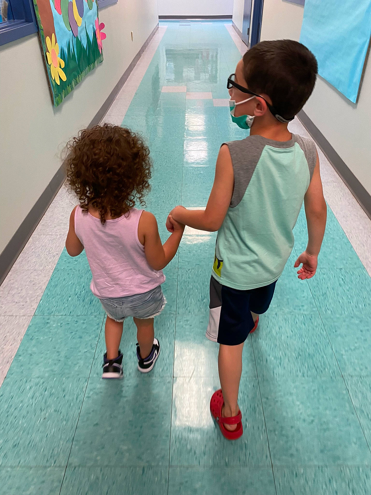 Julian is registered to the contest to win money with this photo: child, eyewear, floor, flooring, fun, gesture, happy, human_body, human_leg, leg, leisure, person, sandal, shoe, shorts, standing, summer, t_shirt, thigh, toddler