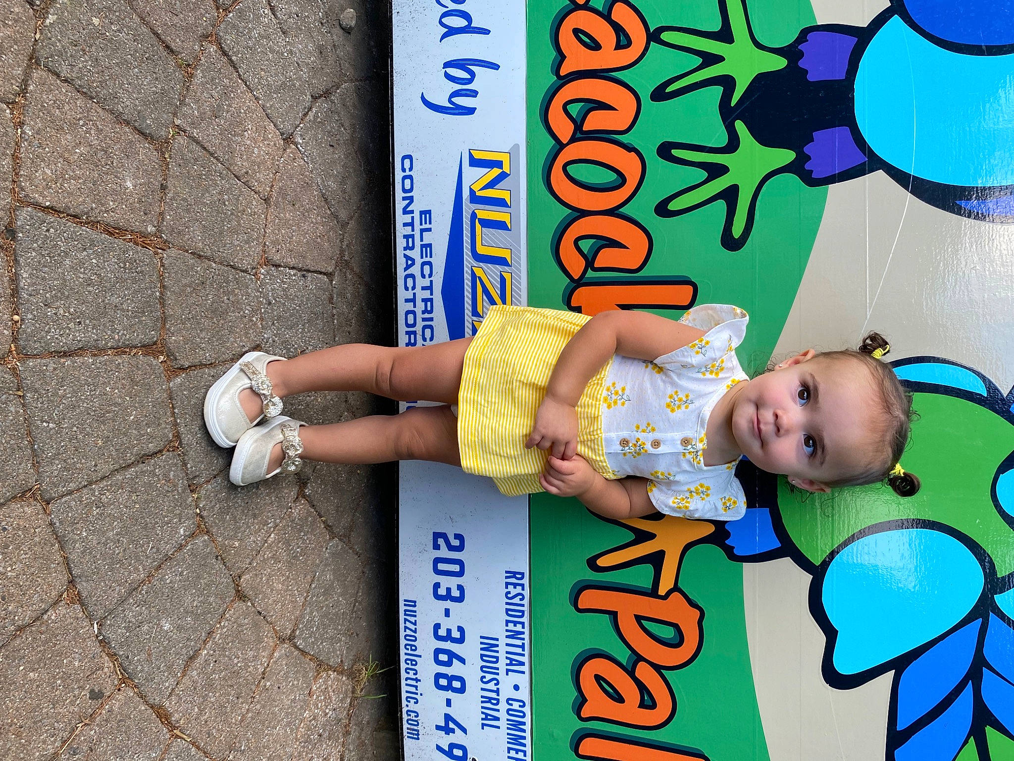 Myliana is registered to the contest to win money with this photo: advertising, baby, baby_products, baby_toddler_clothing, beauty, blue, child, electric_blue, font, fun, happy, human_leg, human_settlement, leisure, person, play, public_space, sidewalk, smile, t_shirt