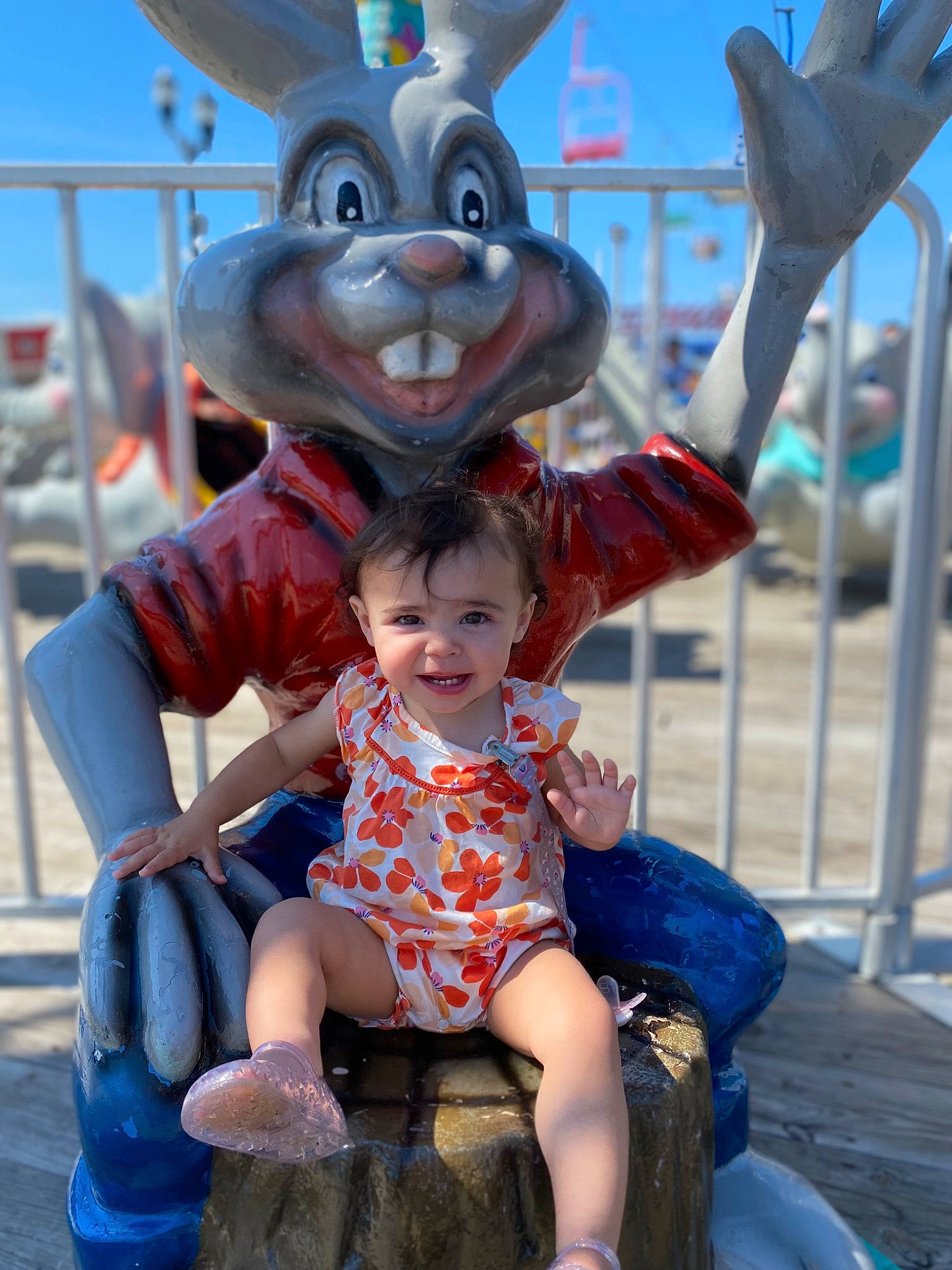 Myliana is registered to the contest to win money with this photo: azure, blue, child, event, fun, happy, joy, leisure, mascot, person, photograph, pink, recreation, shorts, sitting, sky, smile, snapshot, toddler, tourism